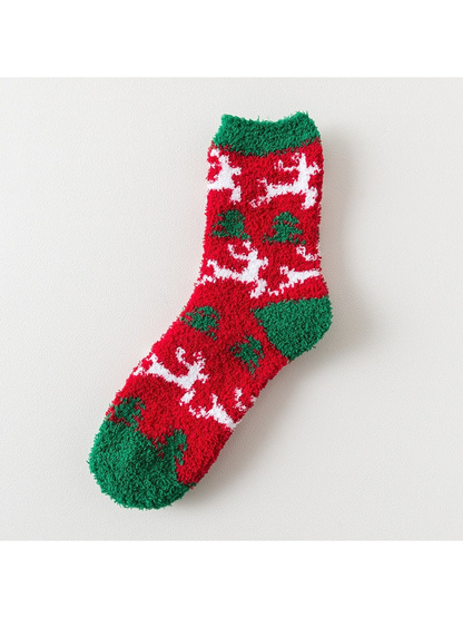 Red fuzzy sock with white reindeer motifs and green trim