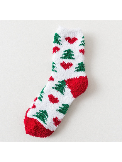 White fuzzy sock with red hearts, green trees and red trim