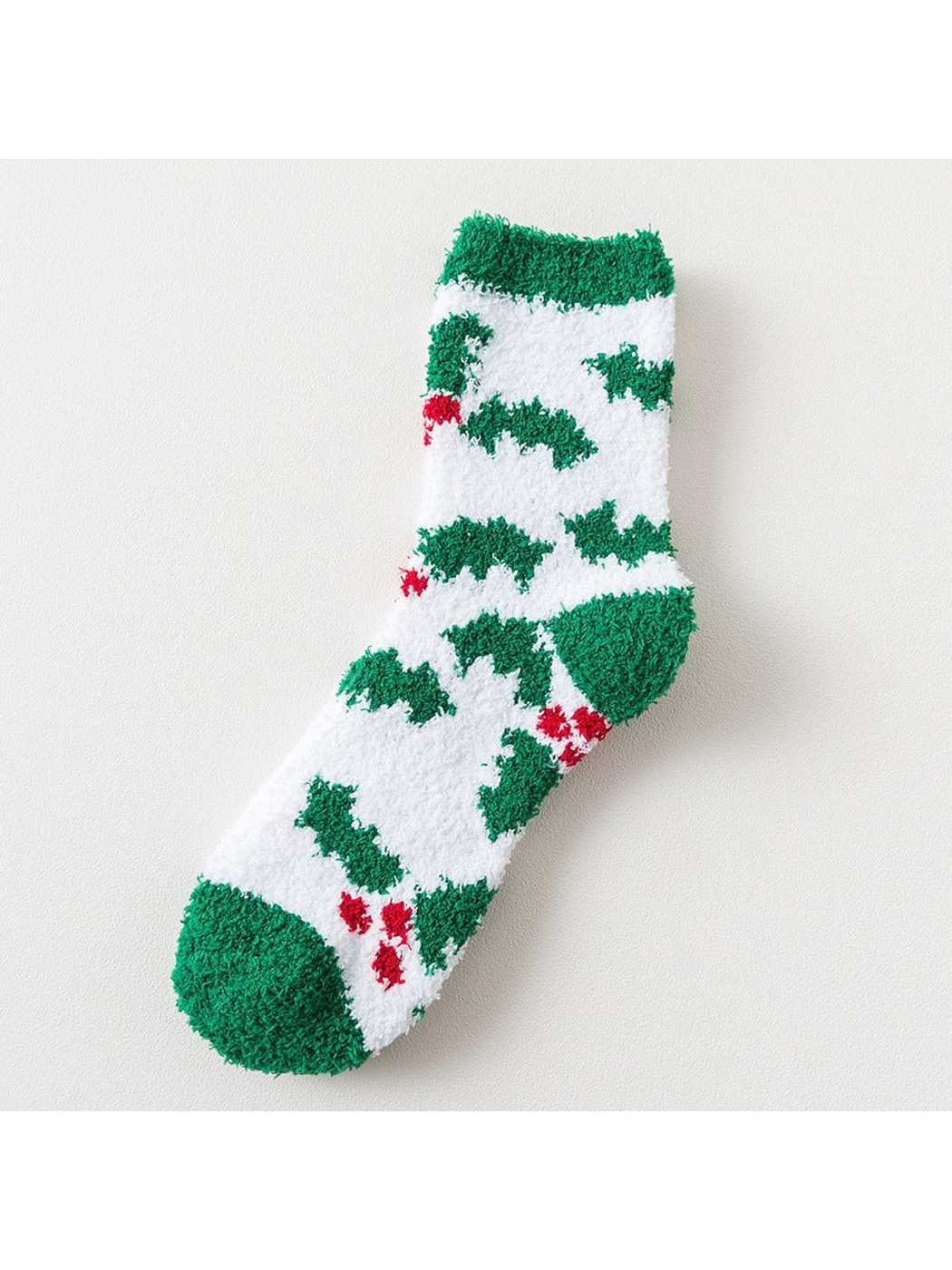 White fuzzy sock with green tree motifs and green trim