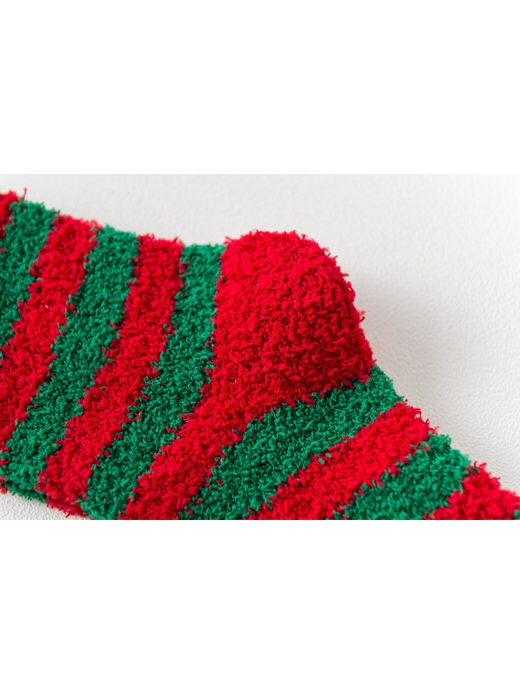 Close-up of the red heel against red and green stripes