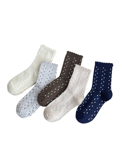 Five colors of dotted crew socks displayed together on a white background