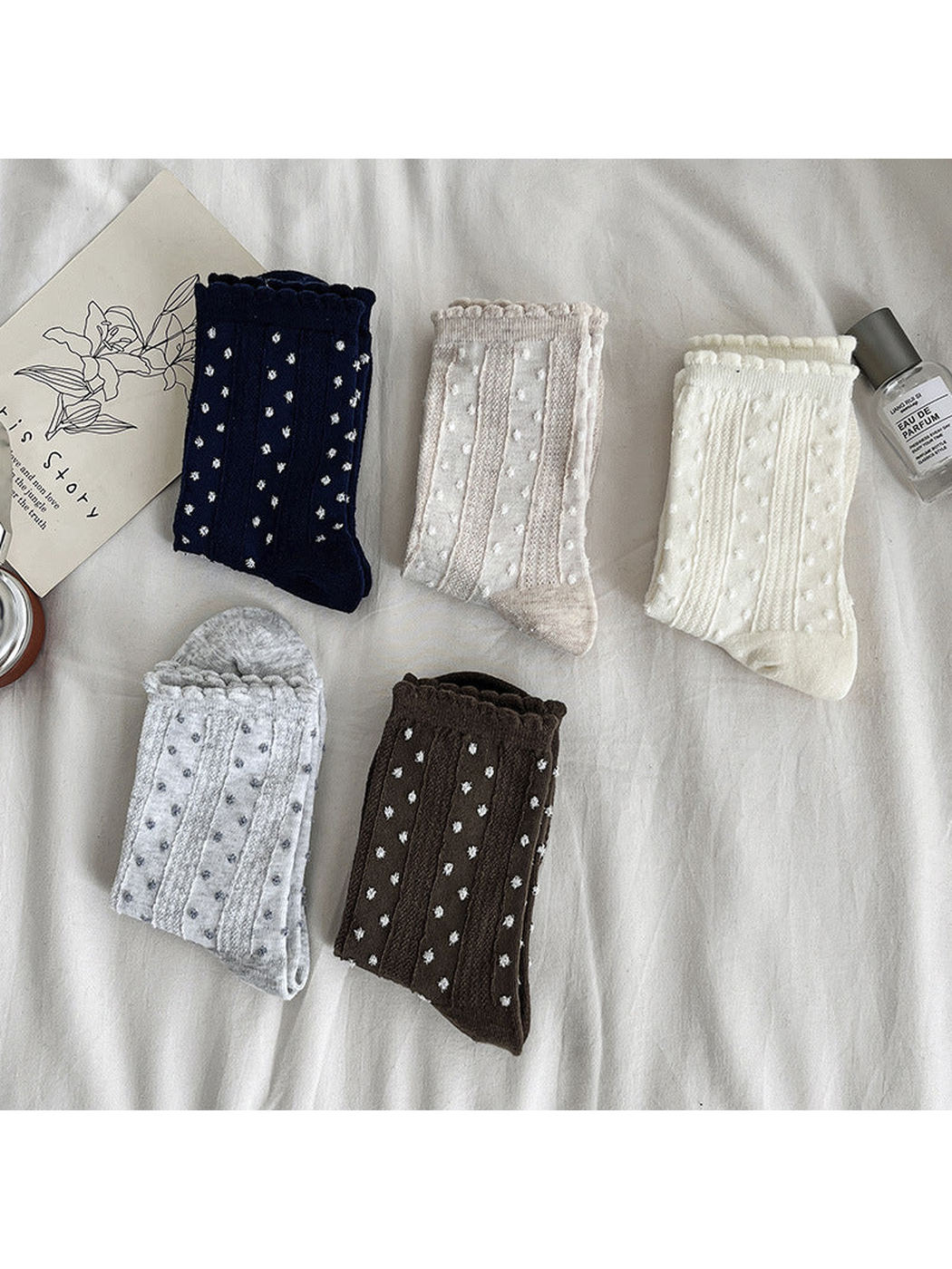 Five dotted crew sock colors folded to show their scalloped cuffs