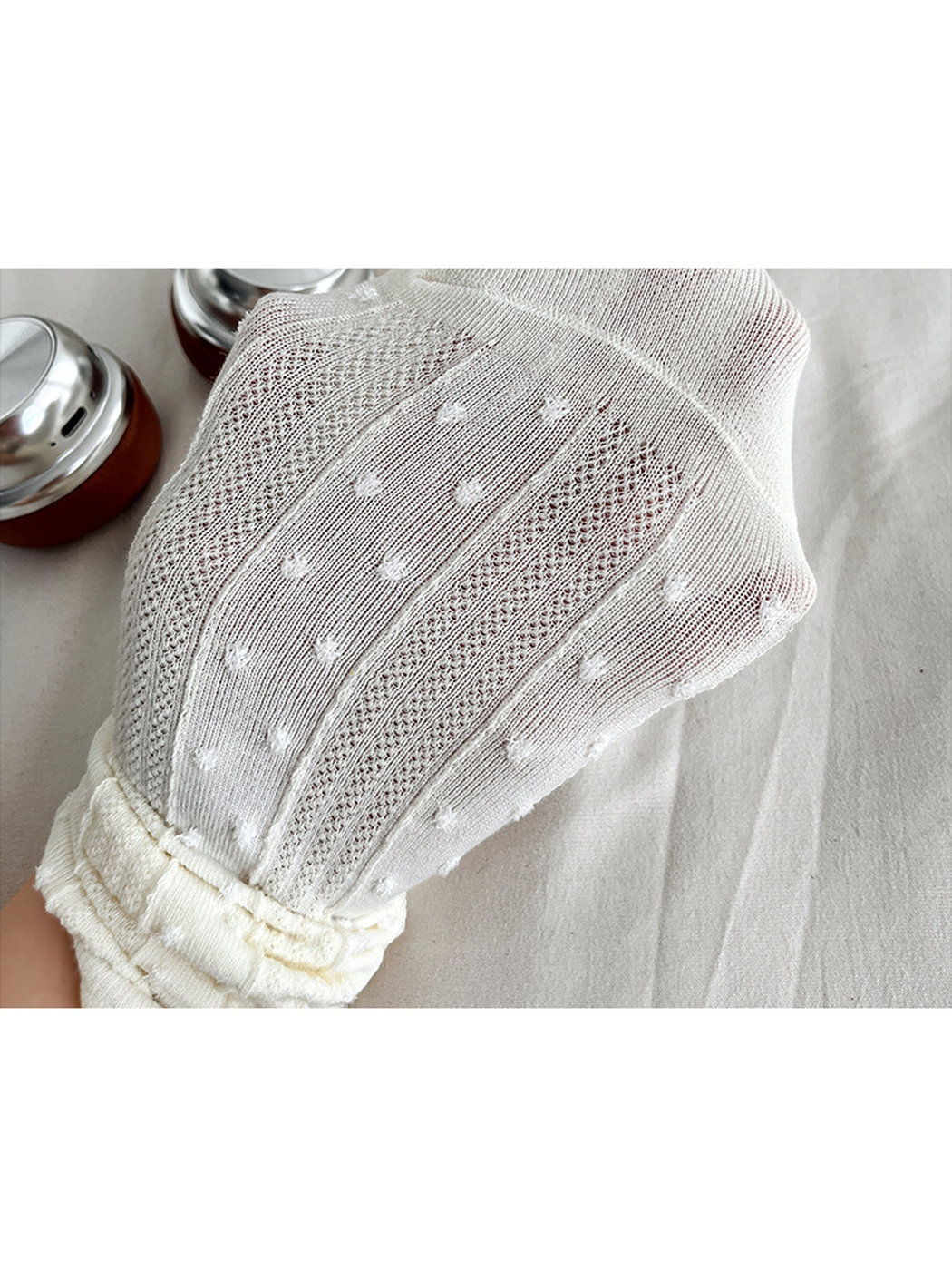 Close-up of the dotted knit and sheer pointelle panels