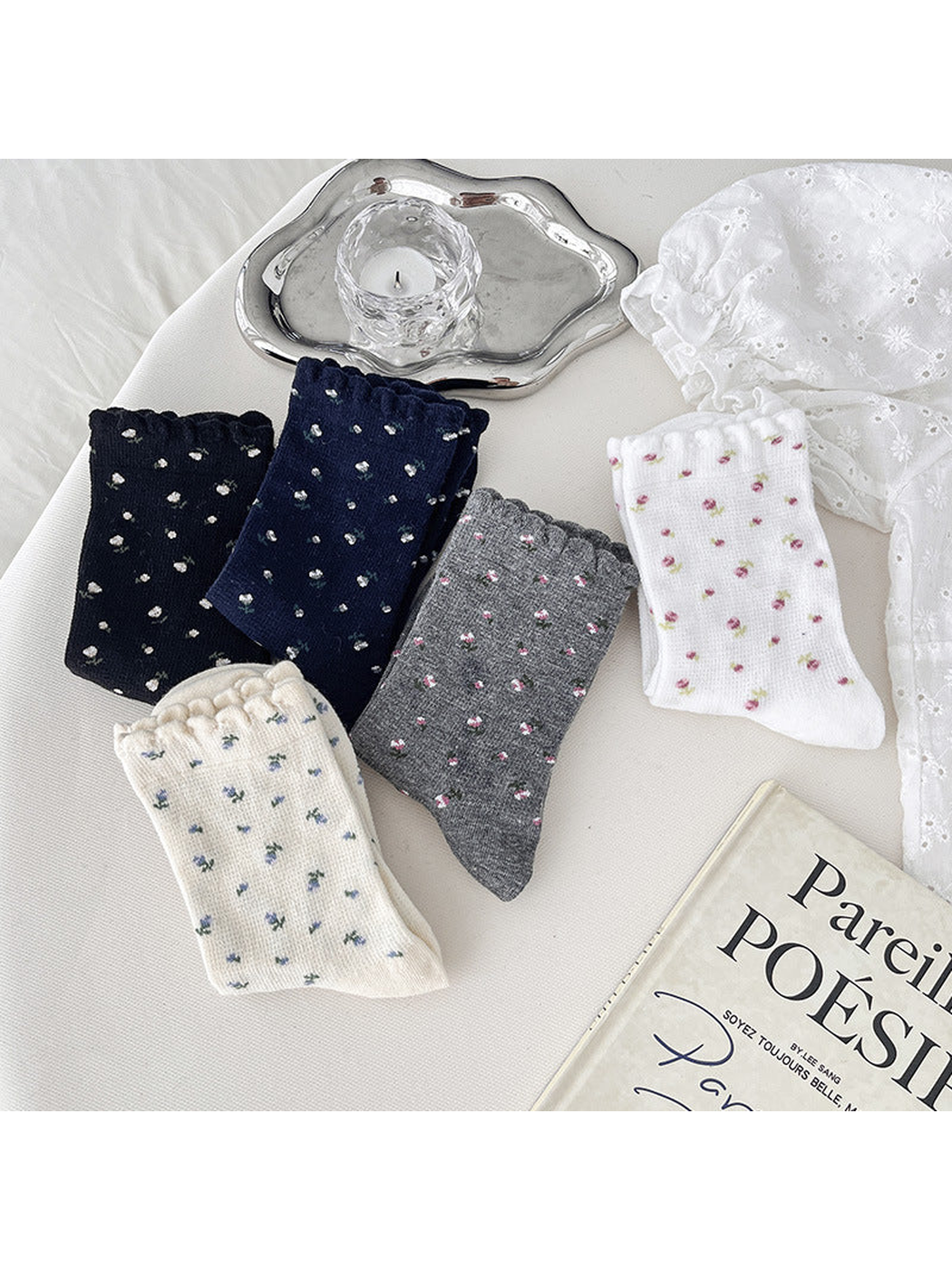 Five floral crew sock colors folded together in a styled flat lay