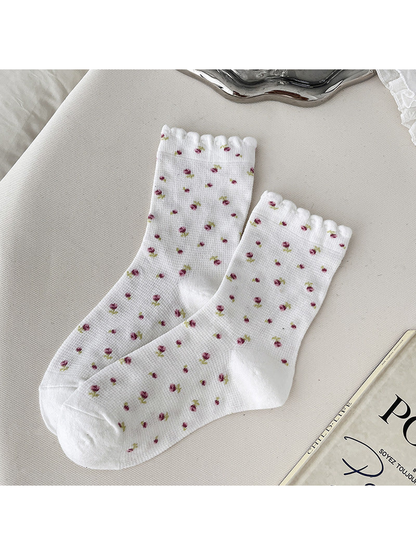 White crew socks with pink floral sprigs and scalloped cuffs