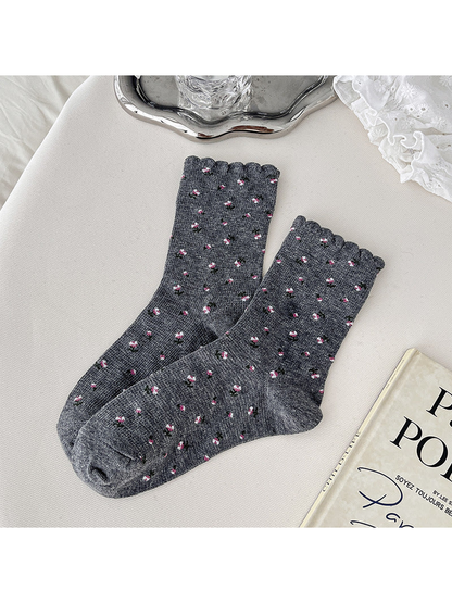 Dark gray crew socks with pink floral sprigs and scalloped cuffs
