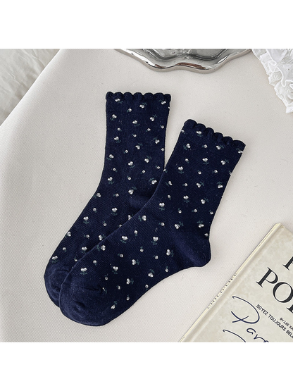 Navy crew socks with small floral sprigs and scalloped cuffs