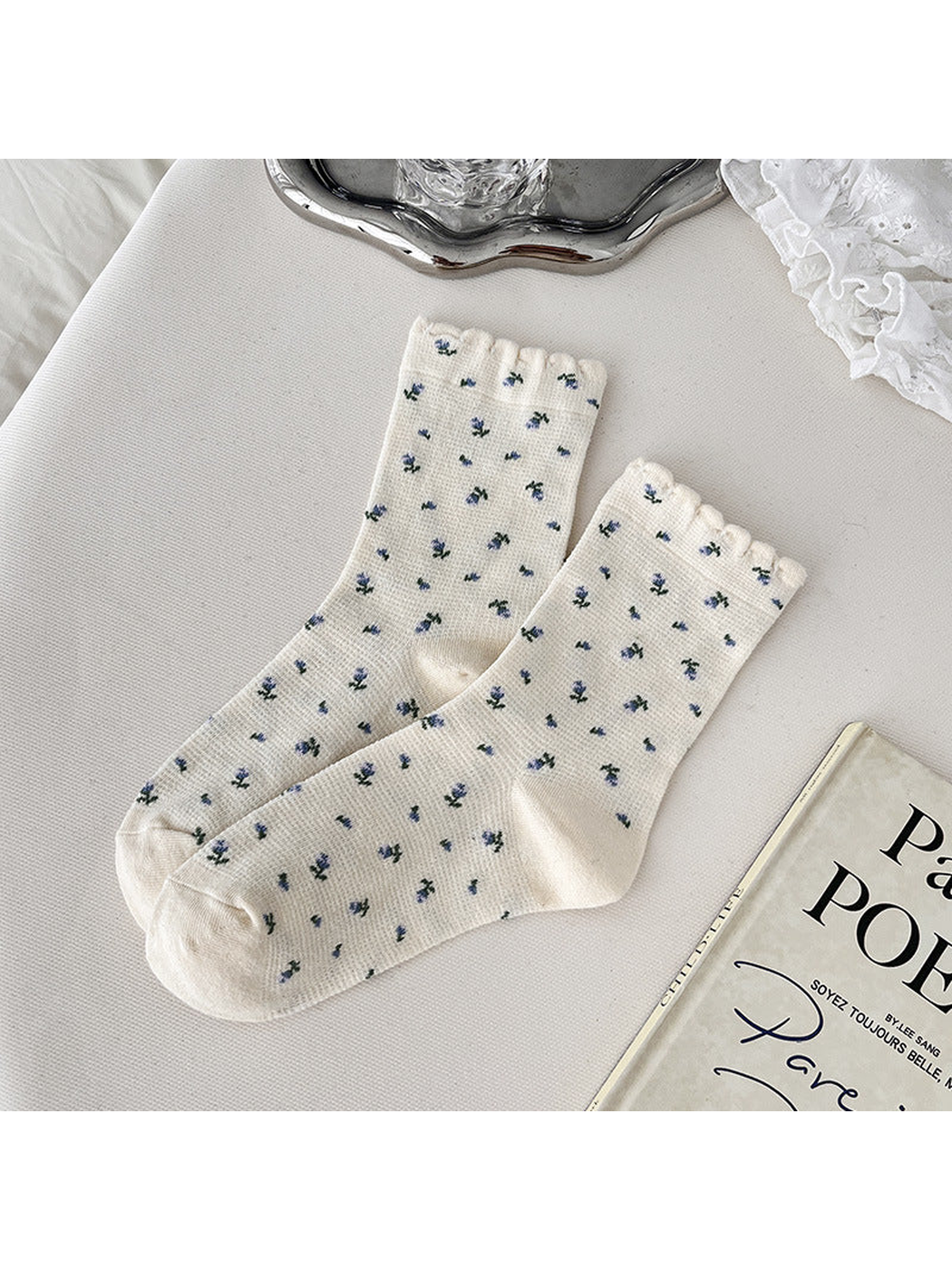 Cream crew socks with blue floral sprigs and scalloped cuffs