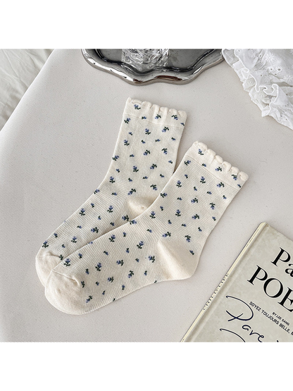 Cream crew socks with blue floral sprigs and scalloped cuffs