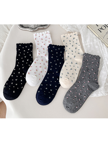 Five floral crew sock colors arranged together on a light background