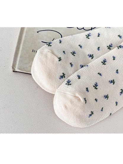 Close-up of the cream floral socks and curved toe seams