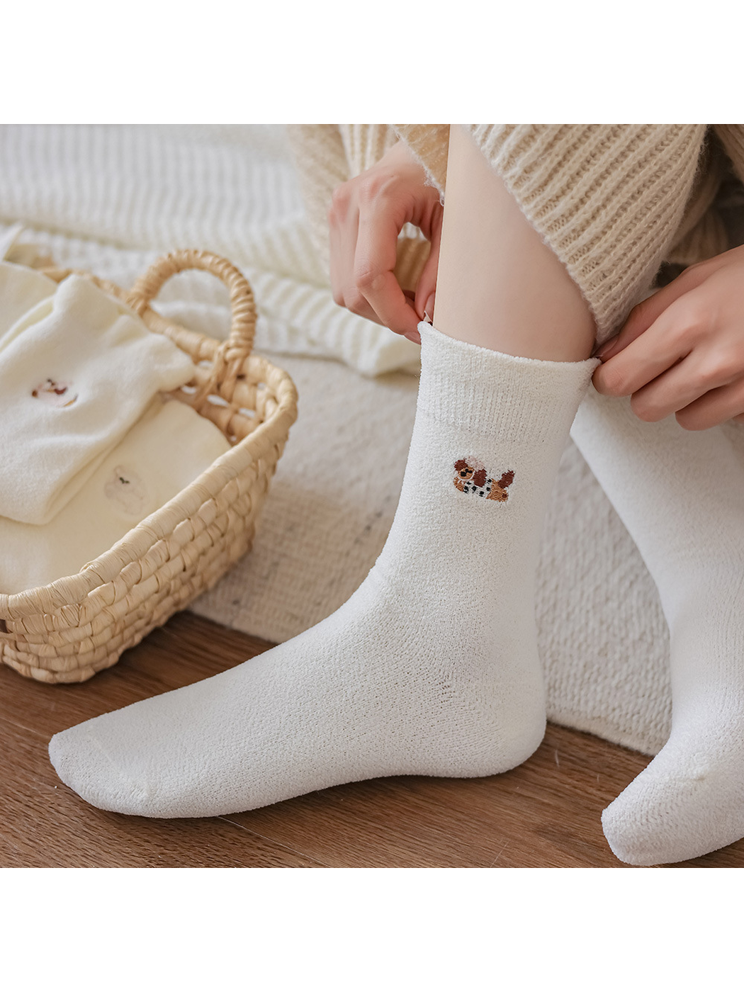 Ivory embroidered crew sock being pulled on in a neutral indoor setting