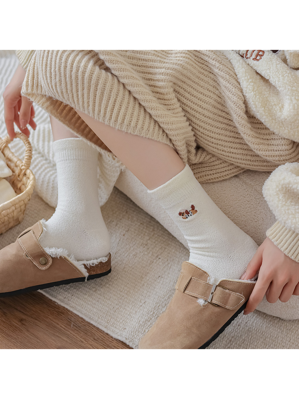 Ivory embroidered crew socks styled with tan buckle clogs