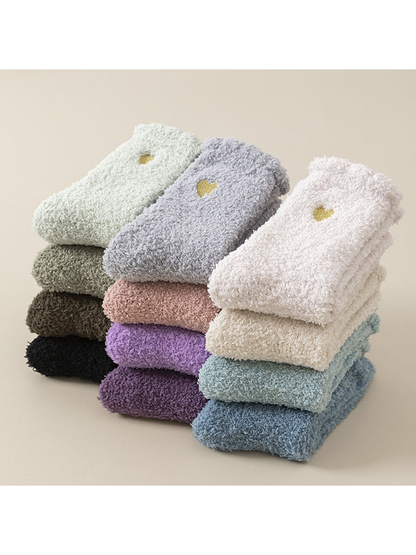 Fuzzy heart-detail socks in multiple colors arranged in folded stacks