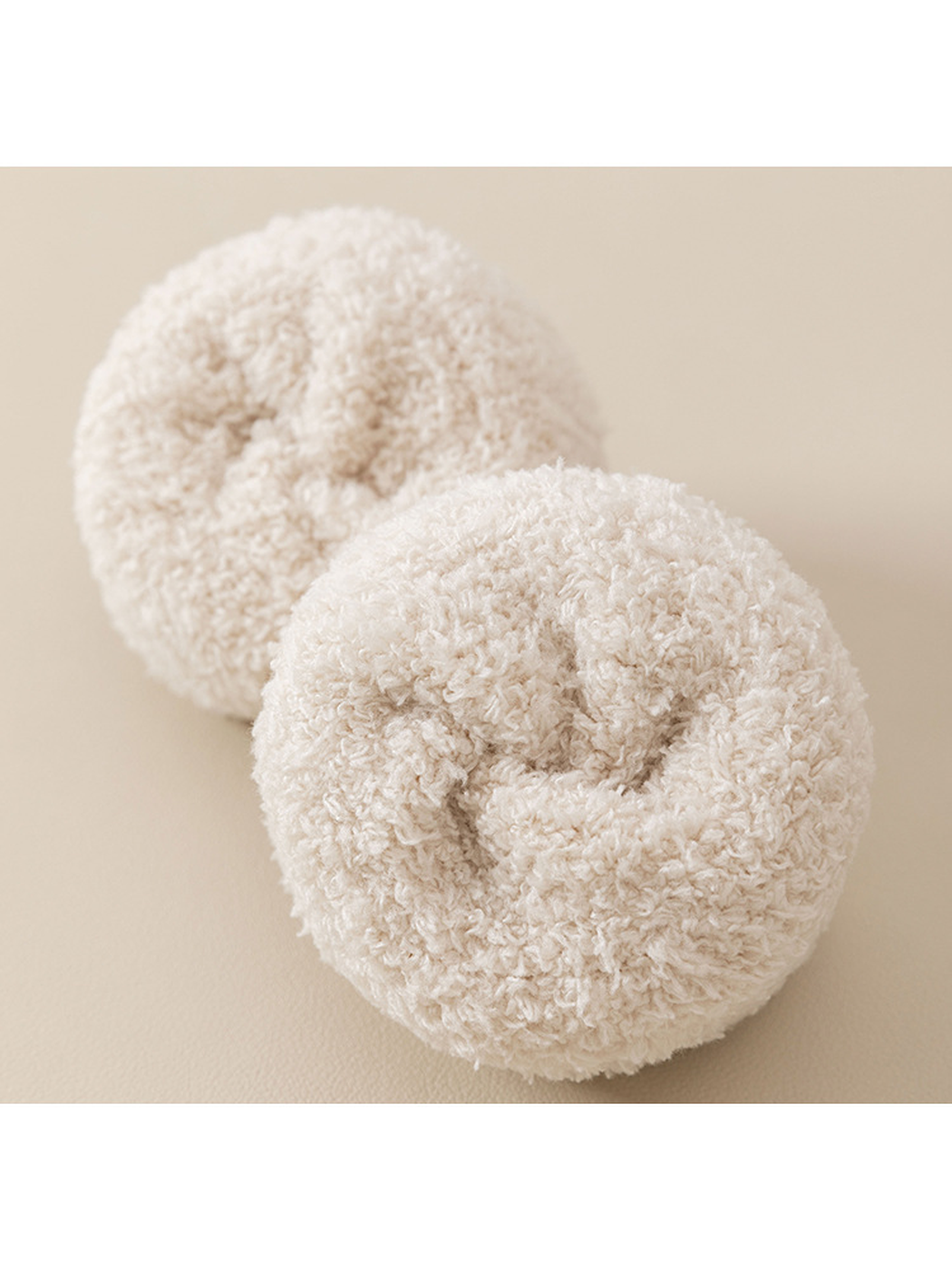 Close-up of the plush looped interior of cream fuzzy socks
