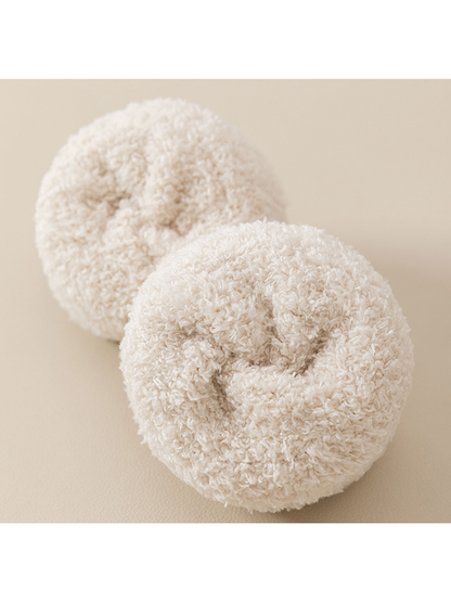 Close-up of the plush looped interior of cream fuzzy socks