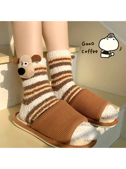Ivory striped dog socks worn with brown open-toe slippers