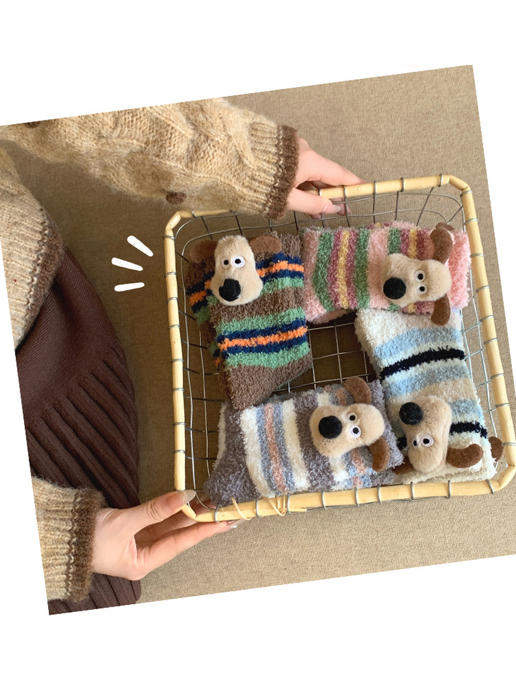 Four folded striped fuzzy dog socks arranged in a wire basket