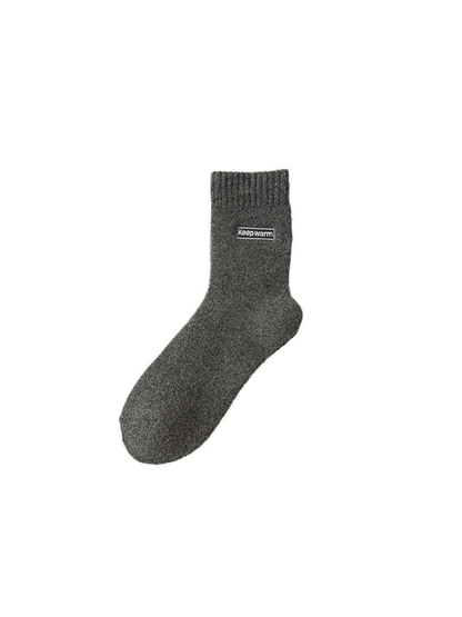Dark gray crew sock with ribbed cuff and label patch