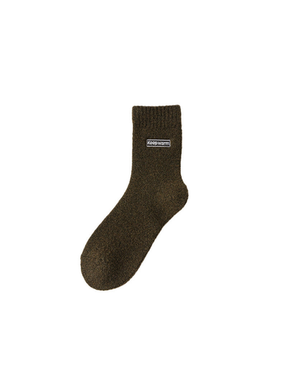 Army green crew sock with ribbed cuff and label patch