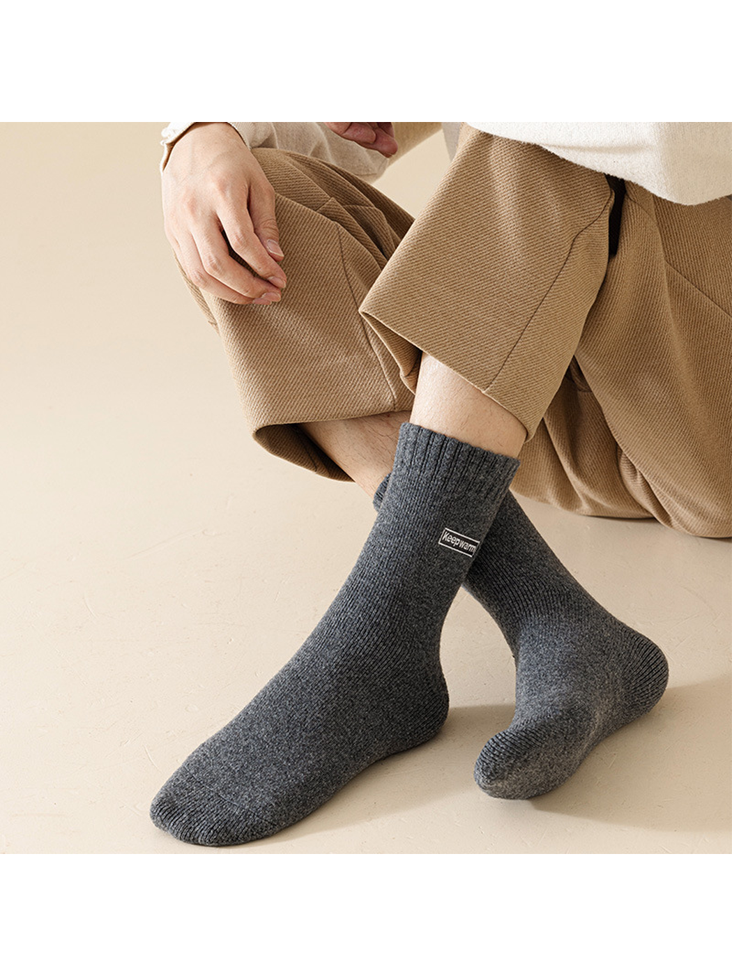 Dark gray crew socks worn with crossed legs