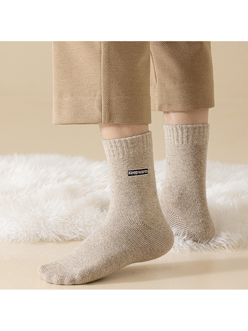 Beige crew socks worn against a light textured backdrop