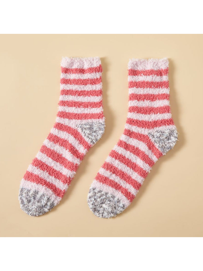 Coral and pale pink striped fuzzy crew socks with mottled gray toes and heels