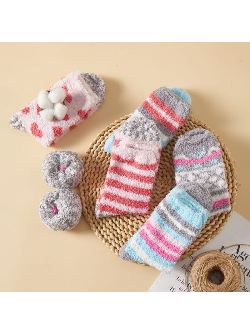 Assorted fuzzy patterned socks styled with a woven mat and yarn