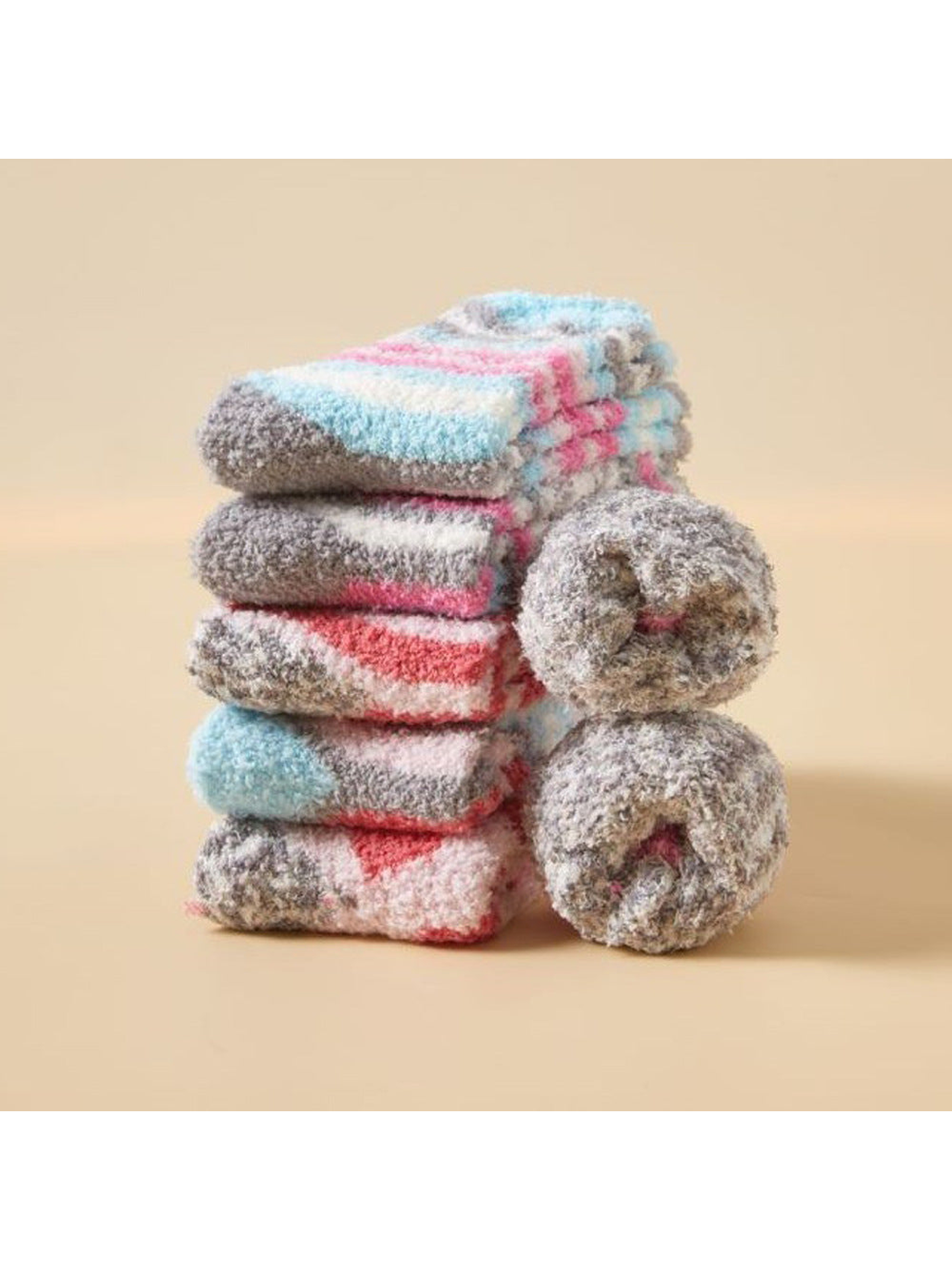 Assorted fuzzy patterned socks displayed folded and rolled