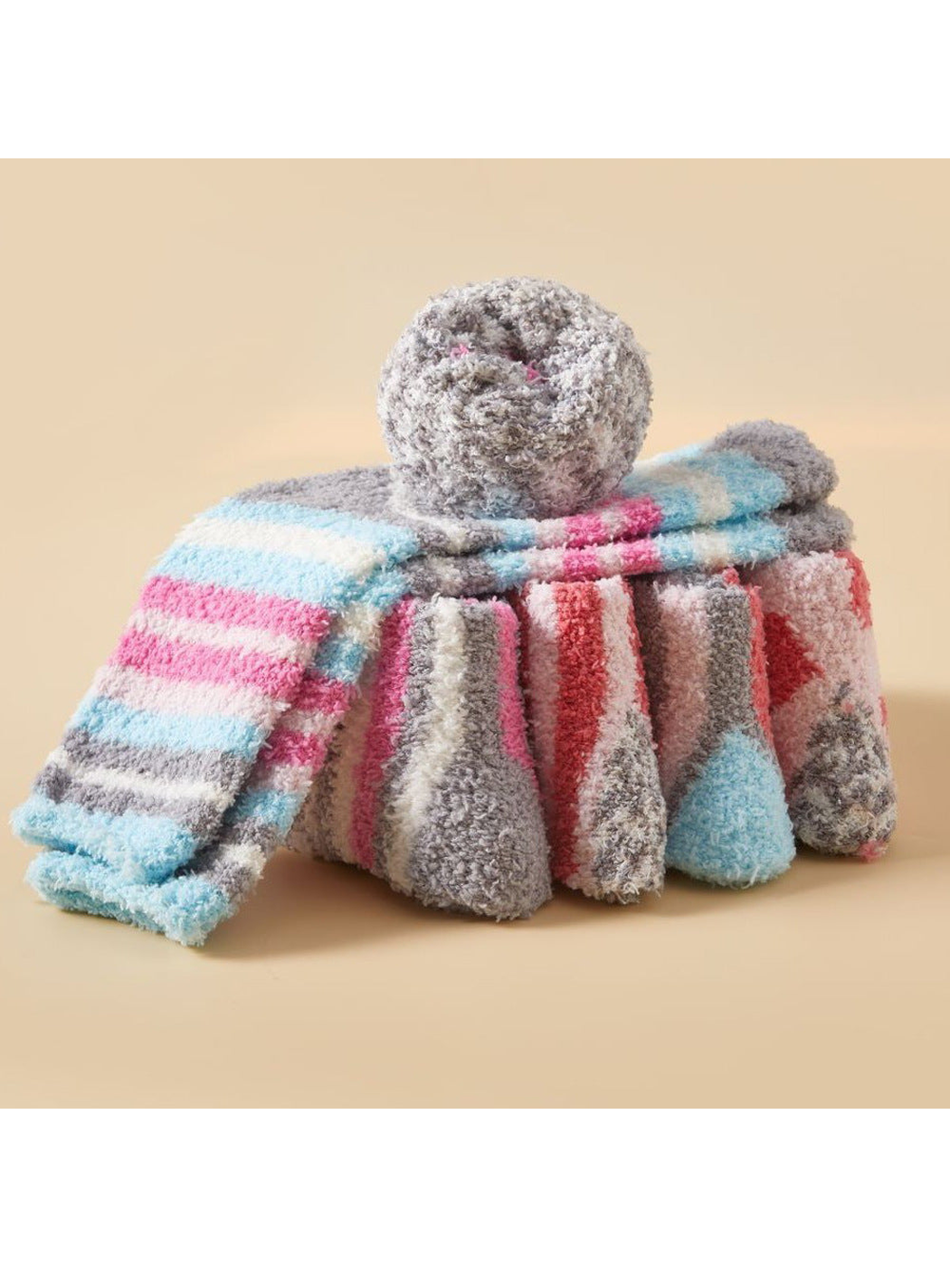 Assorted fuzzy striped socks arranged in a draped display