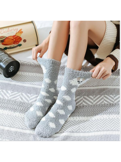 Gray fuzzy polka-dot crew socks worn above the ankle