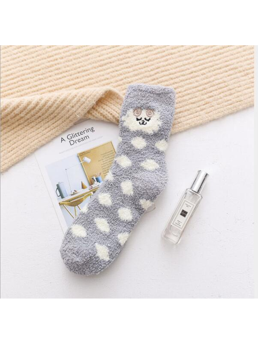 Gray fuzzy crew sock with cream polka dots and embroidered face motif