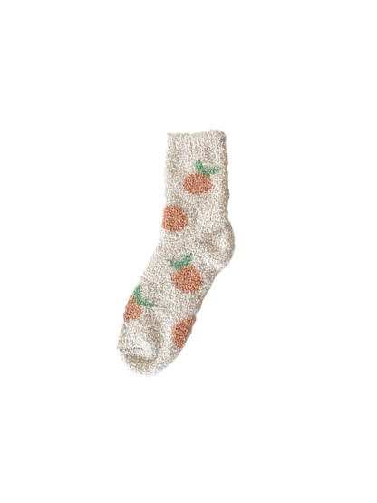 Beige fuzzy crew sock with repeating orange fruit motifs