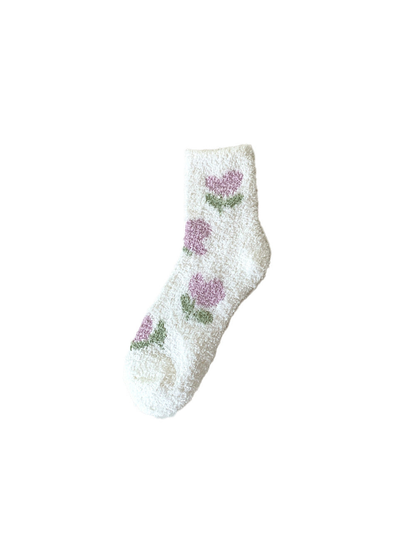 White fuzzy crew sock with repeating purple tulip motifs