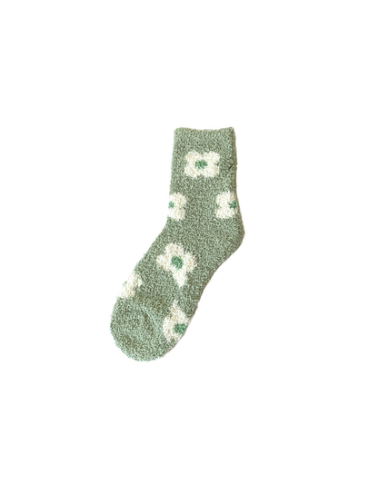 Muted green fuzzy crew sock with repeating cream flower motifs