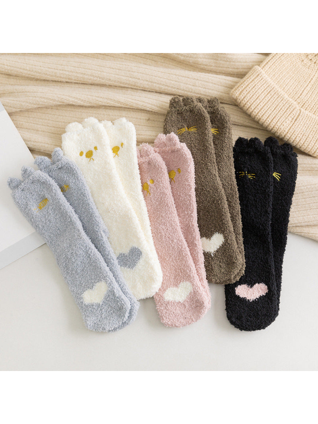 Five colors of fuzzy cat crew socks arranged together