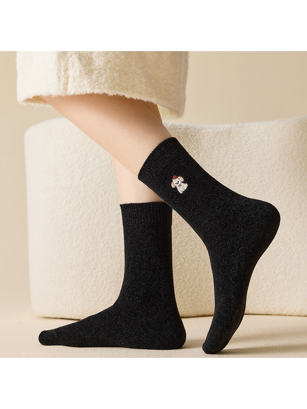 Black embroidered crew socks shown in raised and flat side views