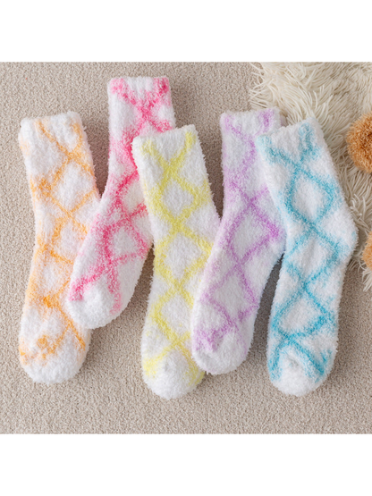 Five fuzzy white crew socks with orange, pink, yellow, purple and blue diamond patterns