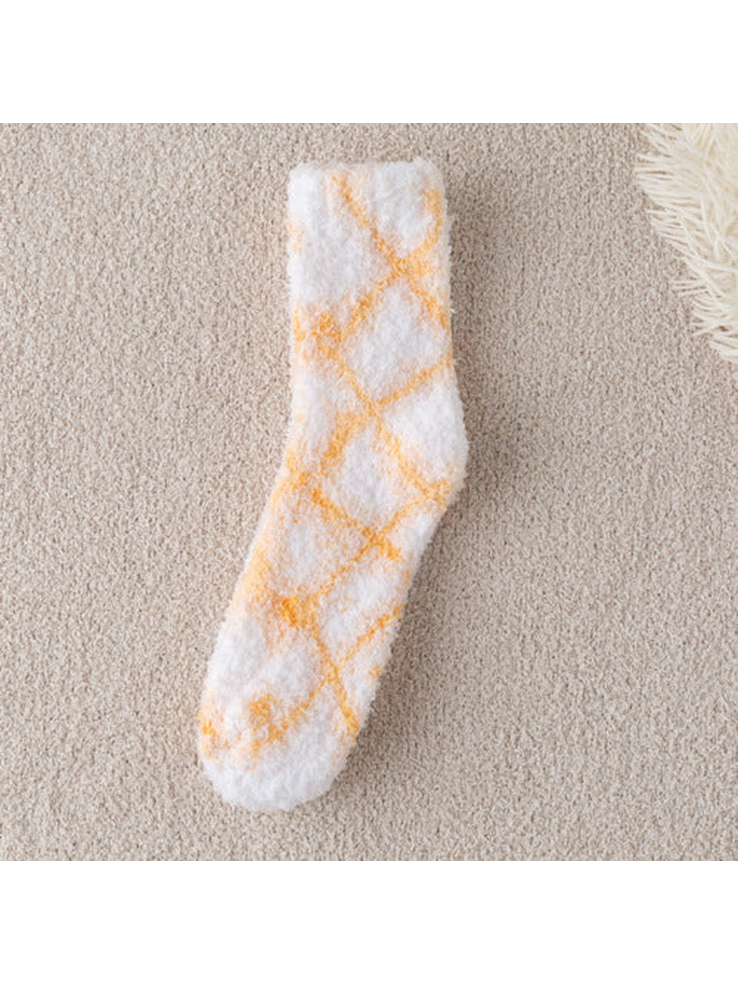 Orange diamond-pattern fuzzy white crew sock, full view