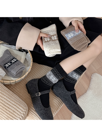 Black snowflake socks worn with charcoal Mary Jane shoes