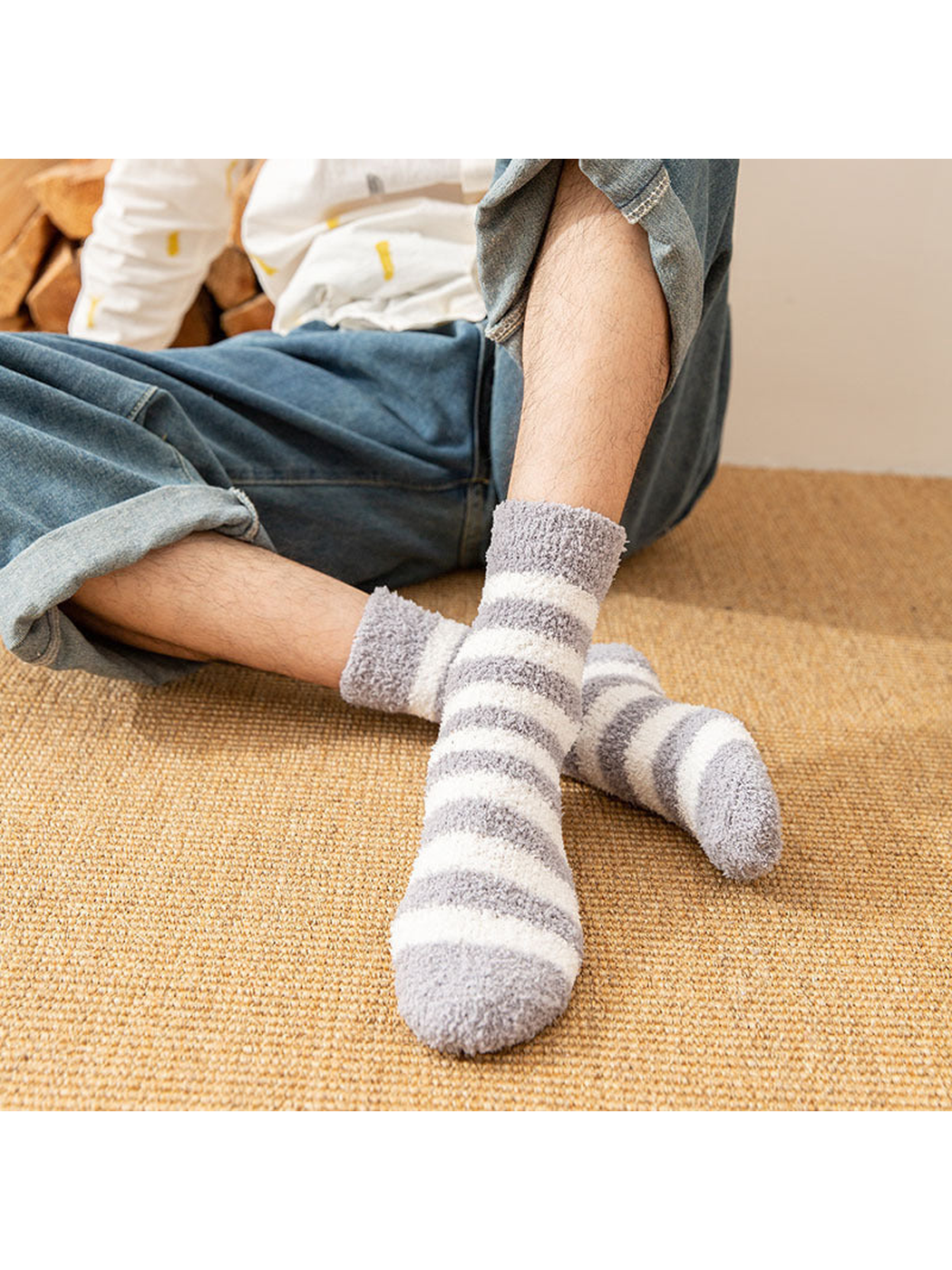 Light gray striped fuzzy crew socks worn while seated