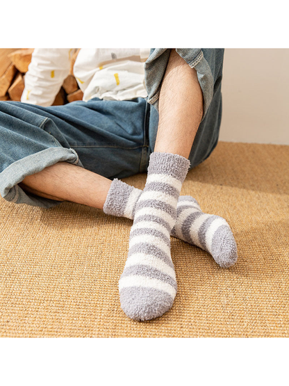 Light gray striped fuzzy crew socks worn while seated