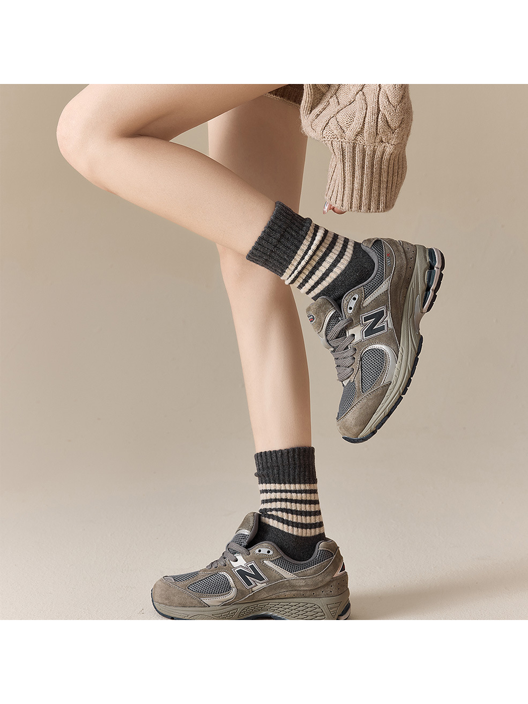 Dark gray striped crew socks styled with gray sneakers