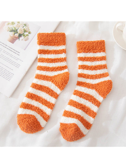 Orange fuzzy socks with cream stripes