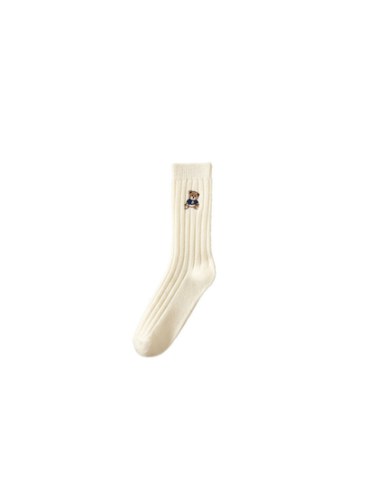 White ribbed crew sock with an embroidered bear in a blue outfit