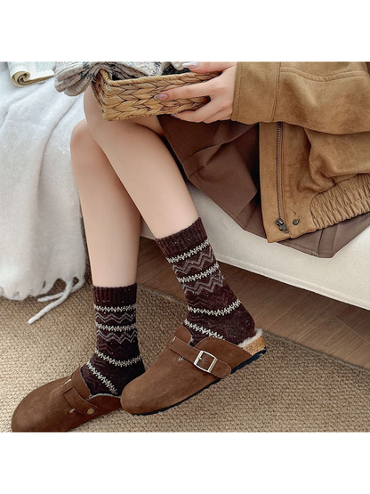 Dark brown geometric crew socks styled with brown clogs