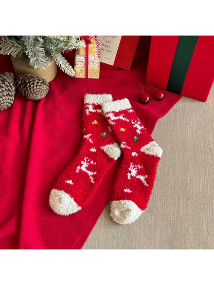 Red fuzzy crew socks with white reindeer motifs and ivory cuffs and toes