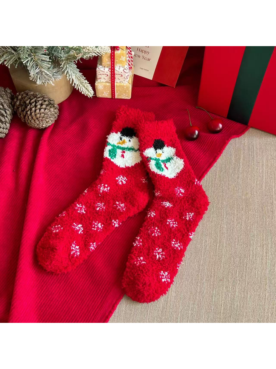 Red fuzzy crew socks with snowman motifs and scattered white snowflakes