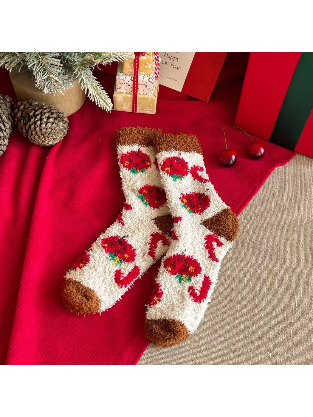 Ivory fuzzy crew socks with red apple motifs and brown cuffs and toes