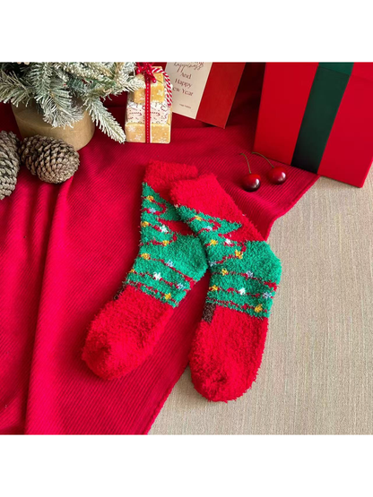 Green fuzzy crew socks with garland tree patterns and red cuffs and toes